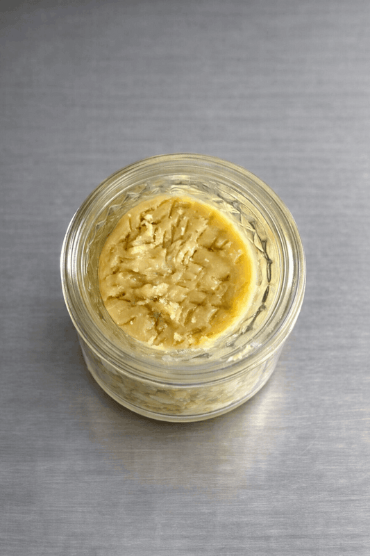 Close-up of 1 gram I Am Hemp Inc Live Hash Rosin concentrate with 78.6% potency in a clear container.