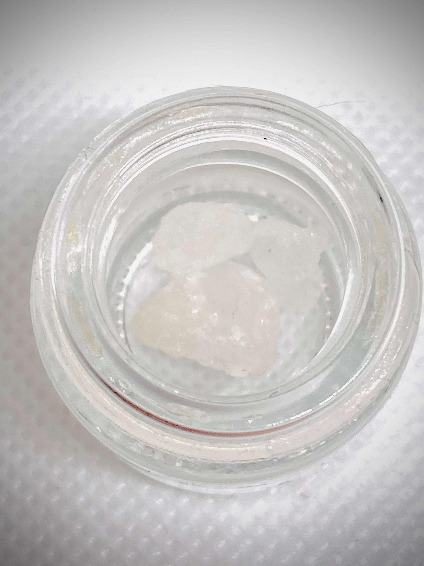 High-quality THCa diamonds concentrate from I Am Hemp Inc with 87% potency, showing clear, crystalline cannabis extract.
