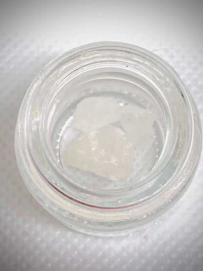 High-quality THCa diamonds concentrate from I Am Hemp Inc with 87% potency, showing clear, crystalline cannabis extract.
