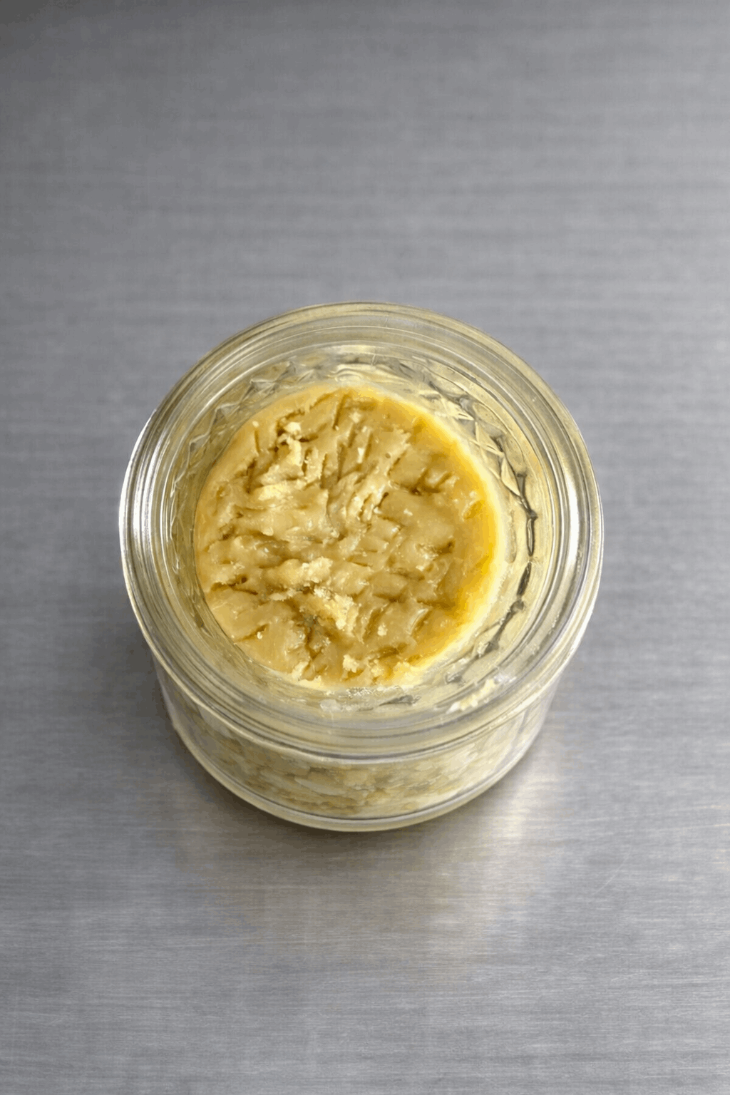 Close-up of 1 gram I Am Hemp Inc Live Hash Rosin concentrate with 78.6% potency in a clear container.