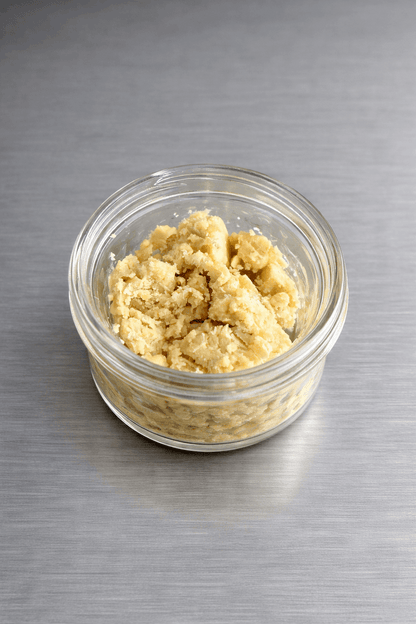 Close-up of 1 gram I Am Hemp Inc Live Hash Rosin concentrate with 78.6% potency, showing its golden, sticky texture and form.