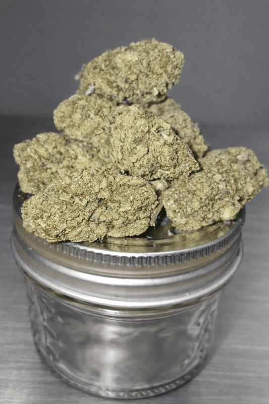 Indoor THCa flower by I Am Hemp Inc, LCG x Permanent Marker strain, showcasing dense, vibrant cannabis buds with trichomes.