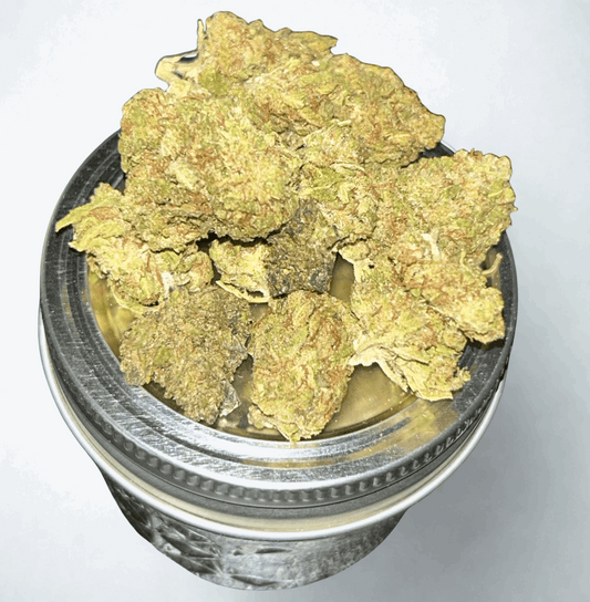 Indoor THCa flower from I Am Hemp Inc, mixed strain, showcasing vibrant, resinous buds with green and purple hues.