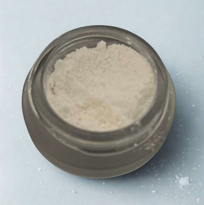 Close-up of THCa Isolate concentrate from I Am Hemp Inc, showing the pure, crystalline 99.8% THC-A isolate in a clear container.