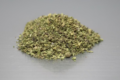 Mixed strain THCa Shake from I Am Hemp Inc, showcasing a close-up of the flower with vibrant green buds and trichomes.