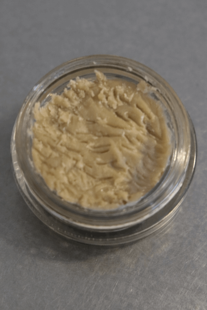 Close-up of 1 gram I Am Hemp Inc Live Hash Rosin concentrate with 78.6% potency in a clear container.